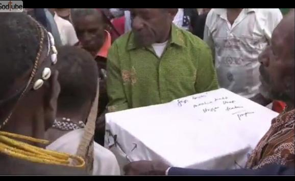 Person presenting signed white document.